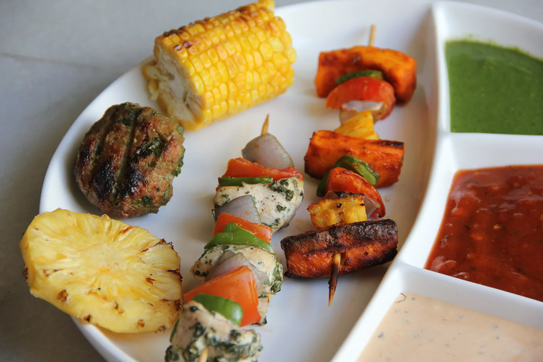 Platter of grilled skewers with dips
